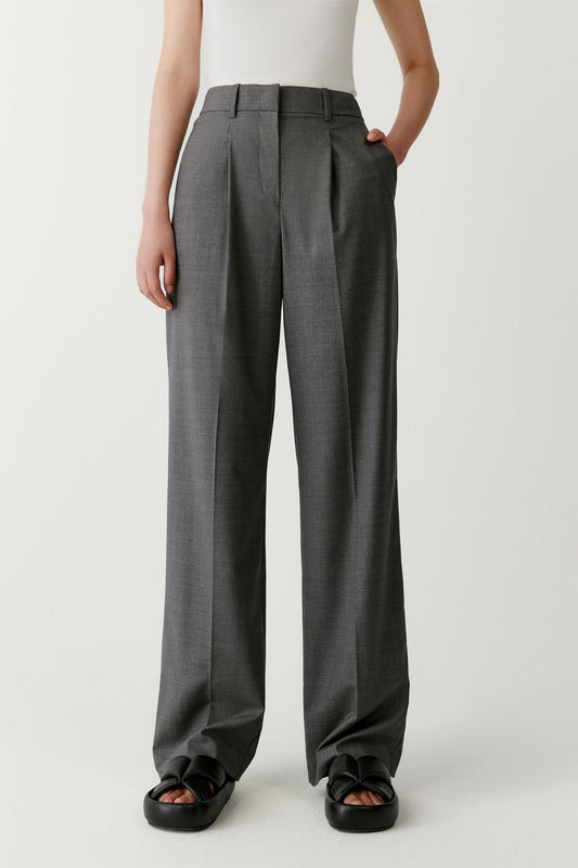 Front view emphasizing the fluid drape of the worsted wool fabric. The straight-leg construction remains consistent from hip to hem, while the lightweight structure of the fabric allows comfortable movement.