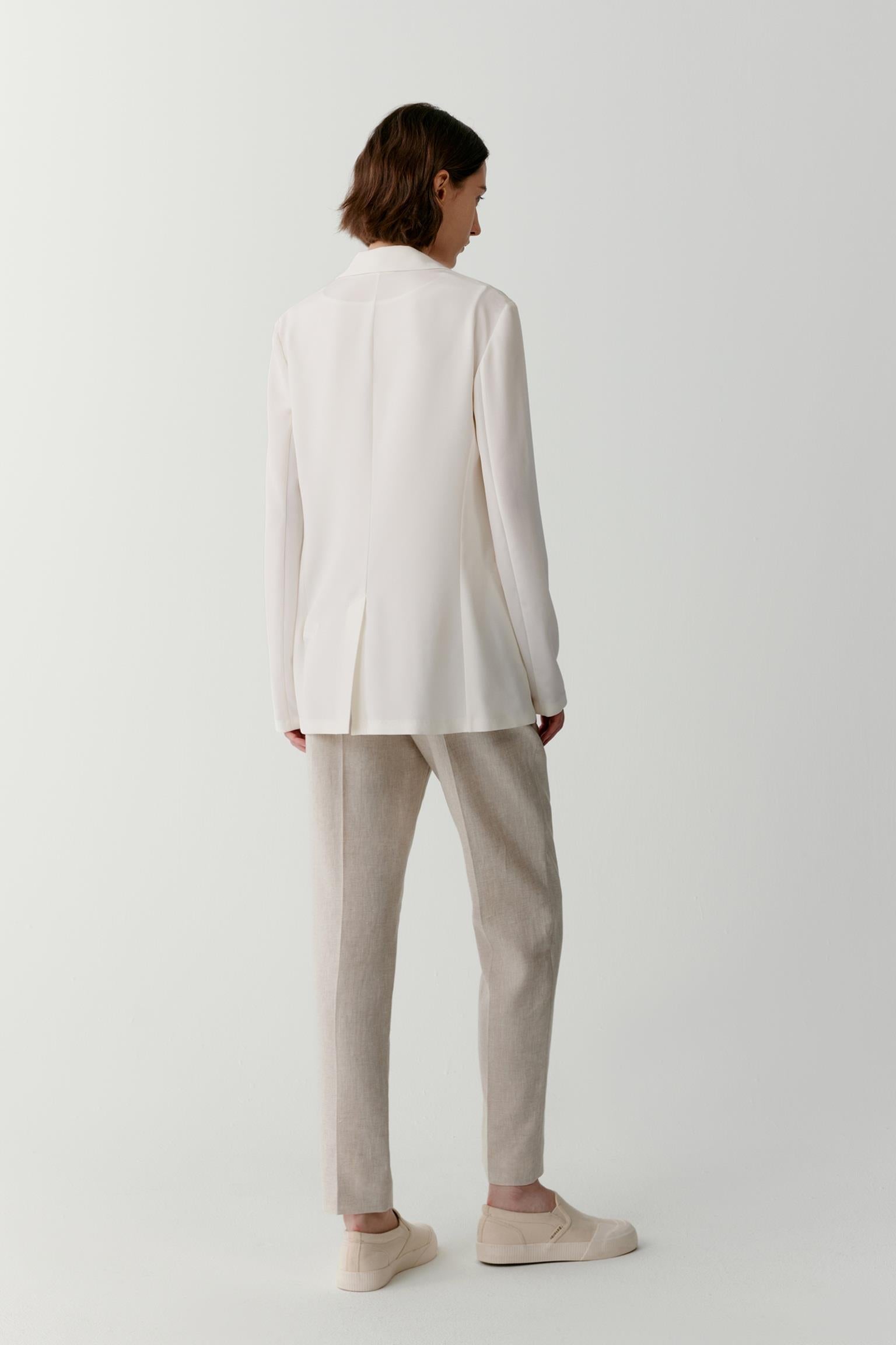 Back view highlighting the straight cut and fluid drape of the fabric. The image showcases the clean construction, long sleeves and uninterrupted silhouette, revealing the lightweight nature of the silk crêpe de Chine.