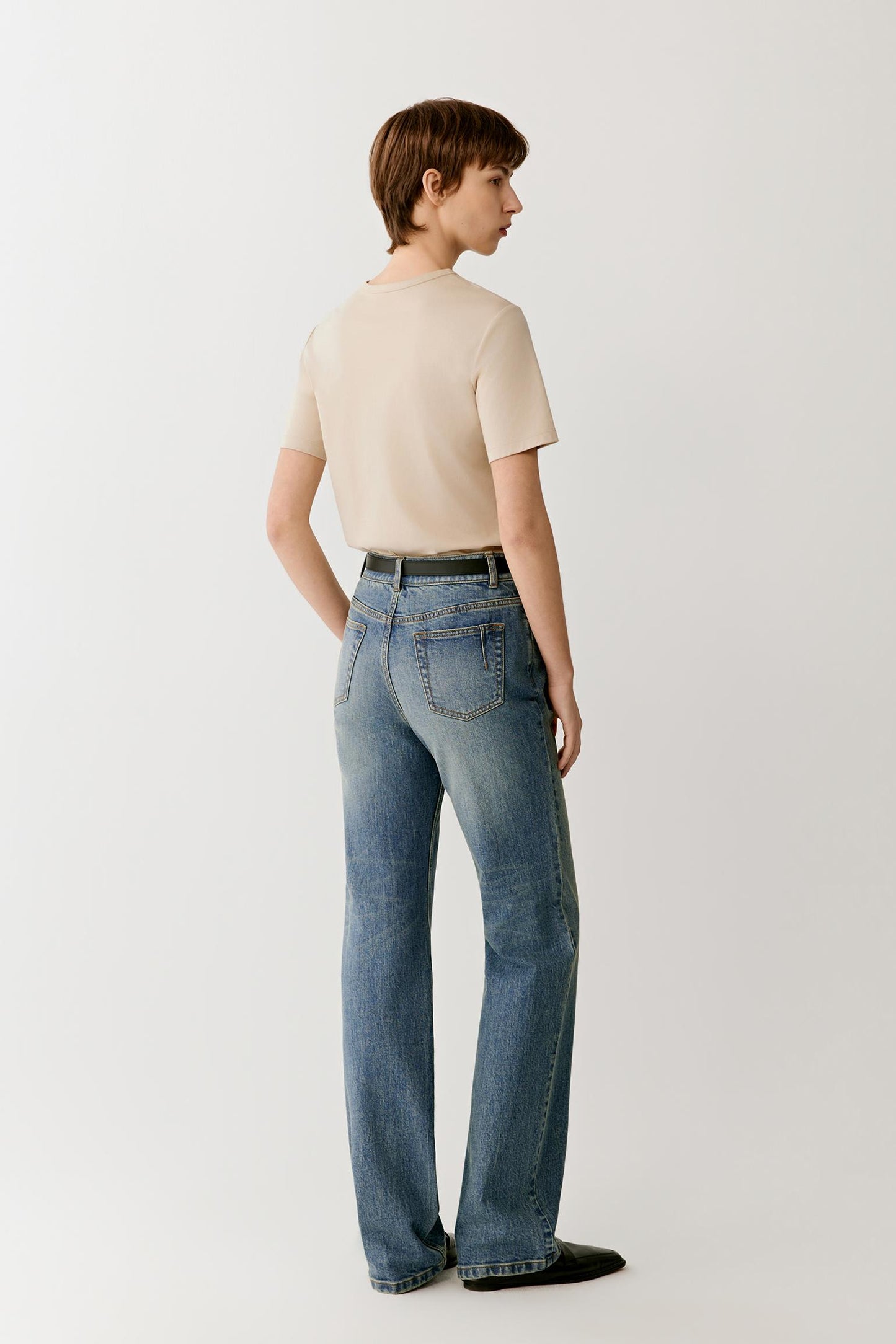 Three-quarter view illustrating the relaxed fit and clean side profile. The smooth cotton jersey maintains a soft structure without stiffness, creating a simple silhouette with natural movement and understated volume.