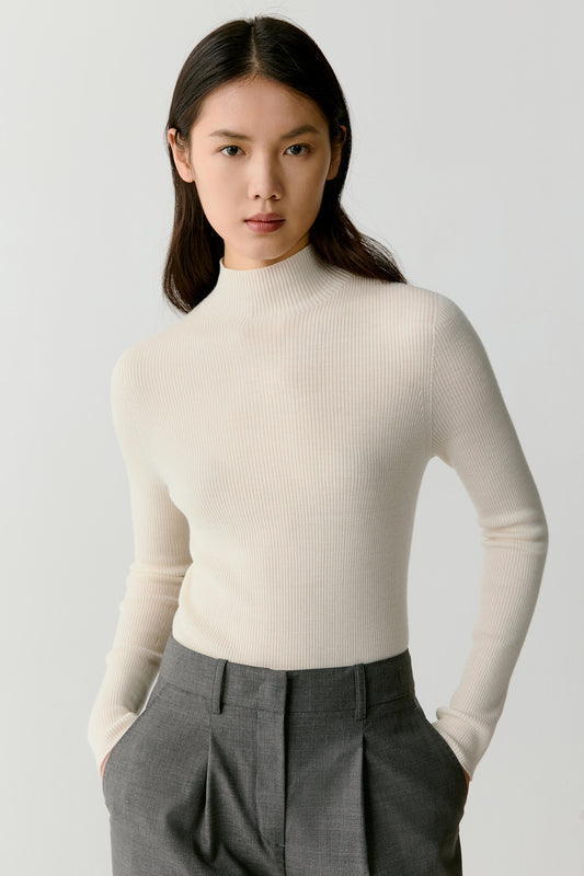 A close-up focuses on the ribbed knit, highlighting the fine, even texture and the softness of the wool against the skin.
