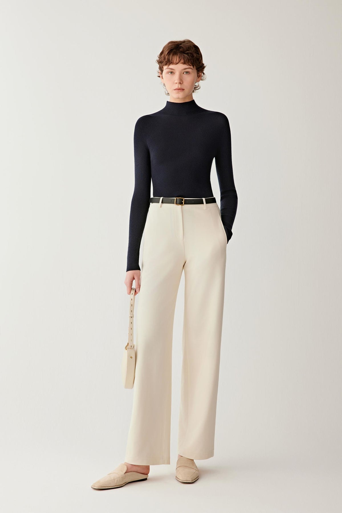 Full-length front view of women’s navy merino wool pullover with mock neckline