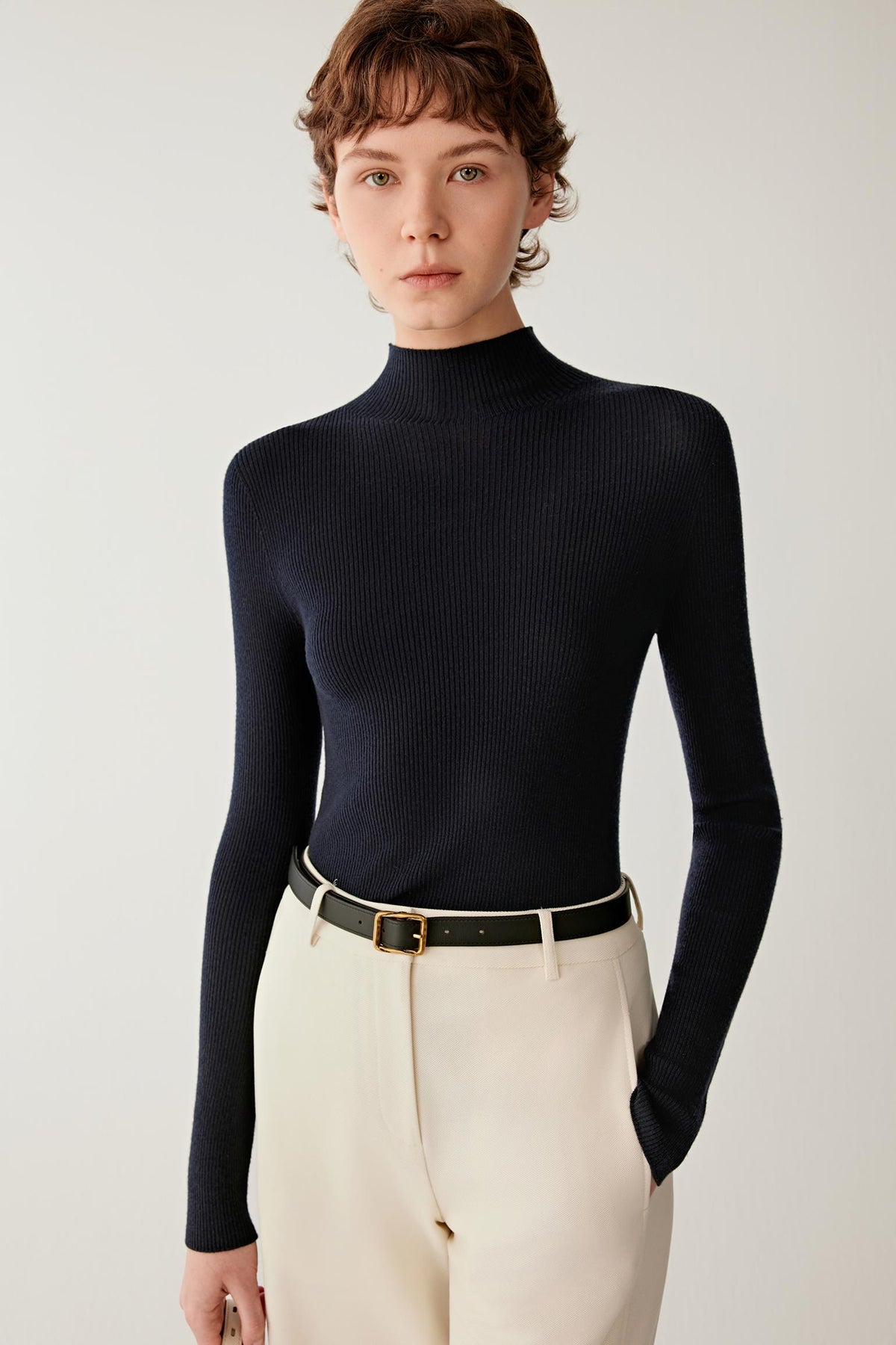 Front view of women’s navy merino wool pullover with mock neckline and long sleeves