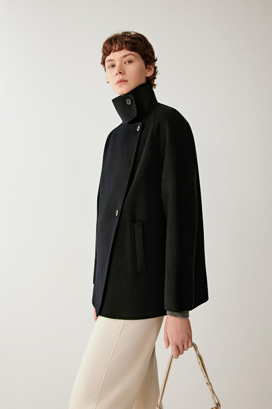 Side view showing the short silhouette, raglan sleeves and structured double-face cashmere construction.