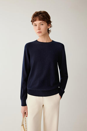 Front view of women’s navy cashmere pullover with crew neckline, long sleeves and a fine-gauge knit