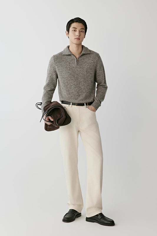 Front view of a man wearing a grey melange twisted cashmere cardigan, showing the stand collar, half-zip fastening and straight silhouette.