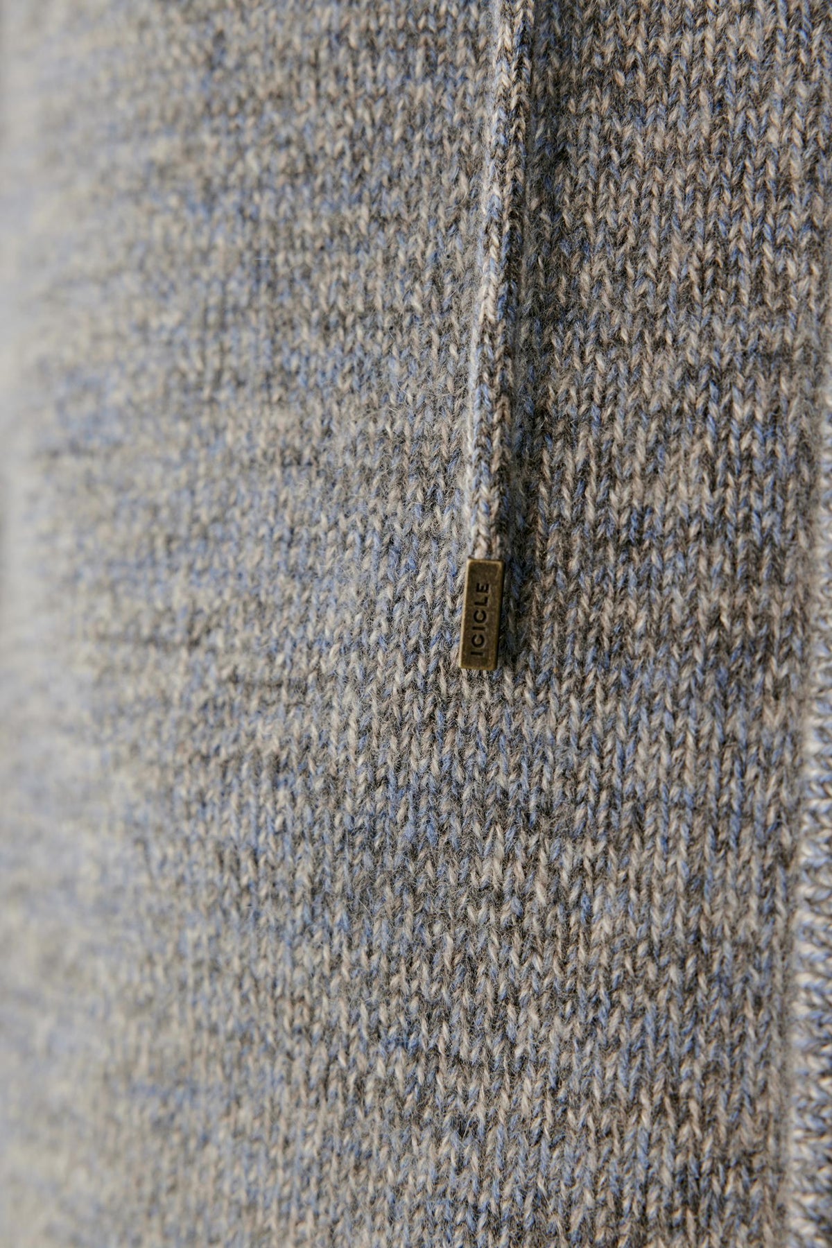 Close-up highlighting the hood drawstring and textured grey melange cashmere knit.
