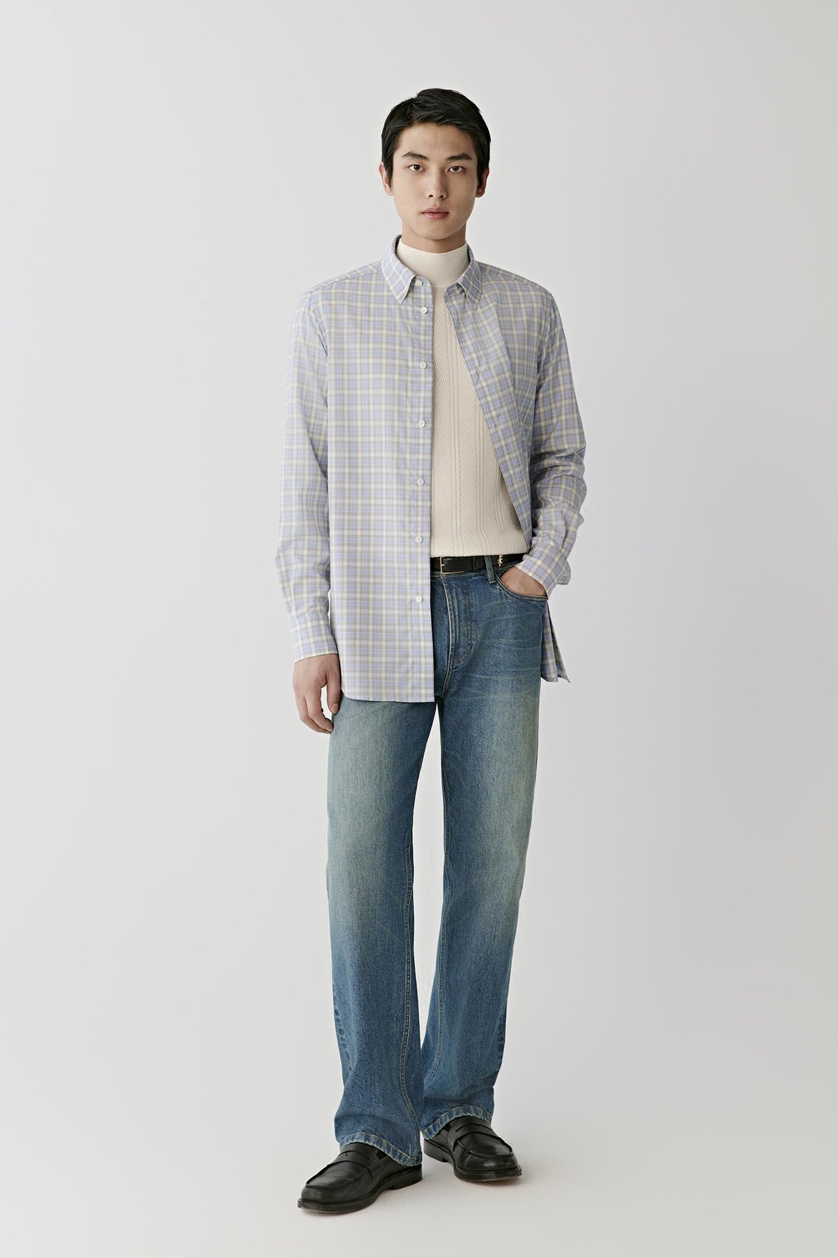 Front full-length view of a man wearing the checked worsted wool shirt, showing the straight silhouette and long sleeves.