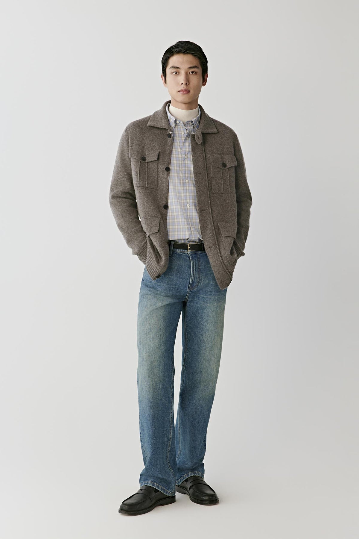 Front full-length view of a man wearing the brown melange cashmere cardigan, highlighting the straight silhouette and long sleeves.