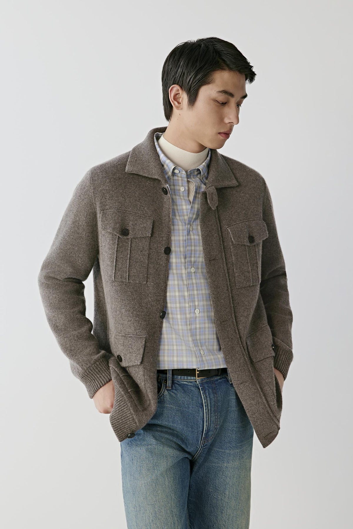 Front view of a man wearing a brown melange cashmere cardigan, showing the shirt collar, button-front fastening and flap patch pockets.