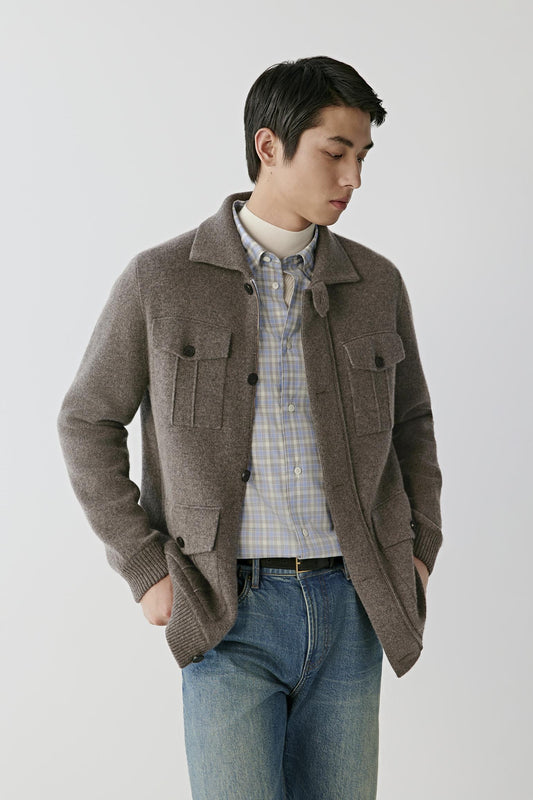 Front view of a man wearing a brown melange cashmere cardigan, showing the shirt collar, button-front fastening and flap patch pockets.