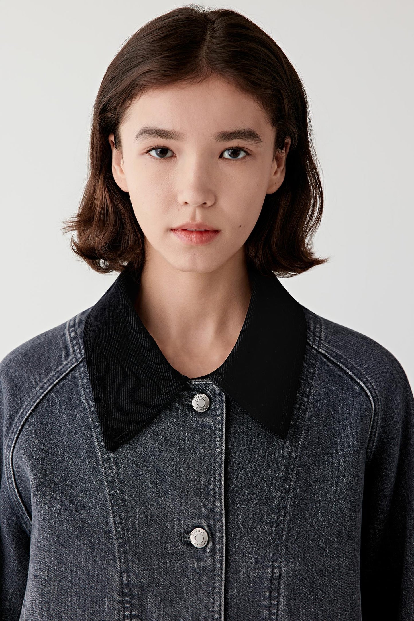 Close-up portrait showing the structured collar and front placket.