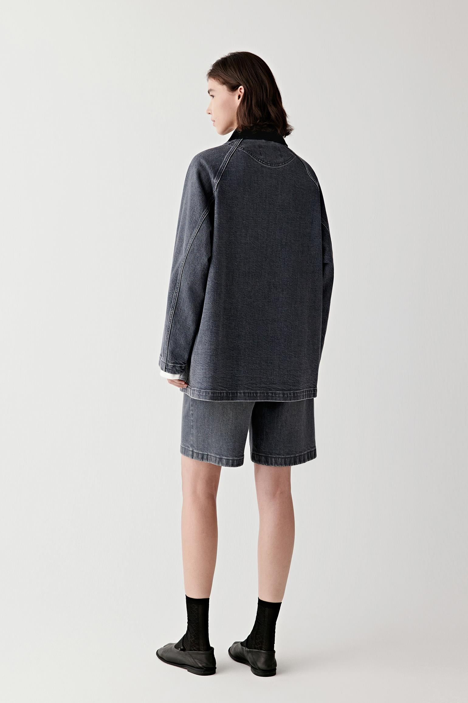 Side view emphasizing the straight silhouette and mid-length cut.