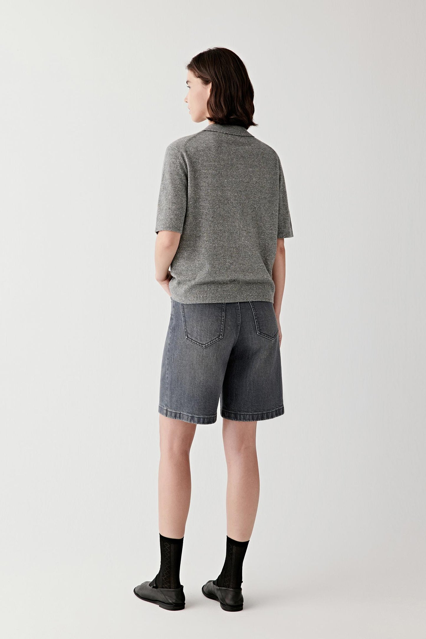 Back view highlighting pocket placement and structured denim finish.