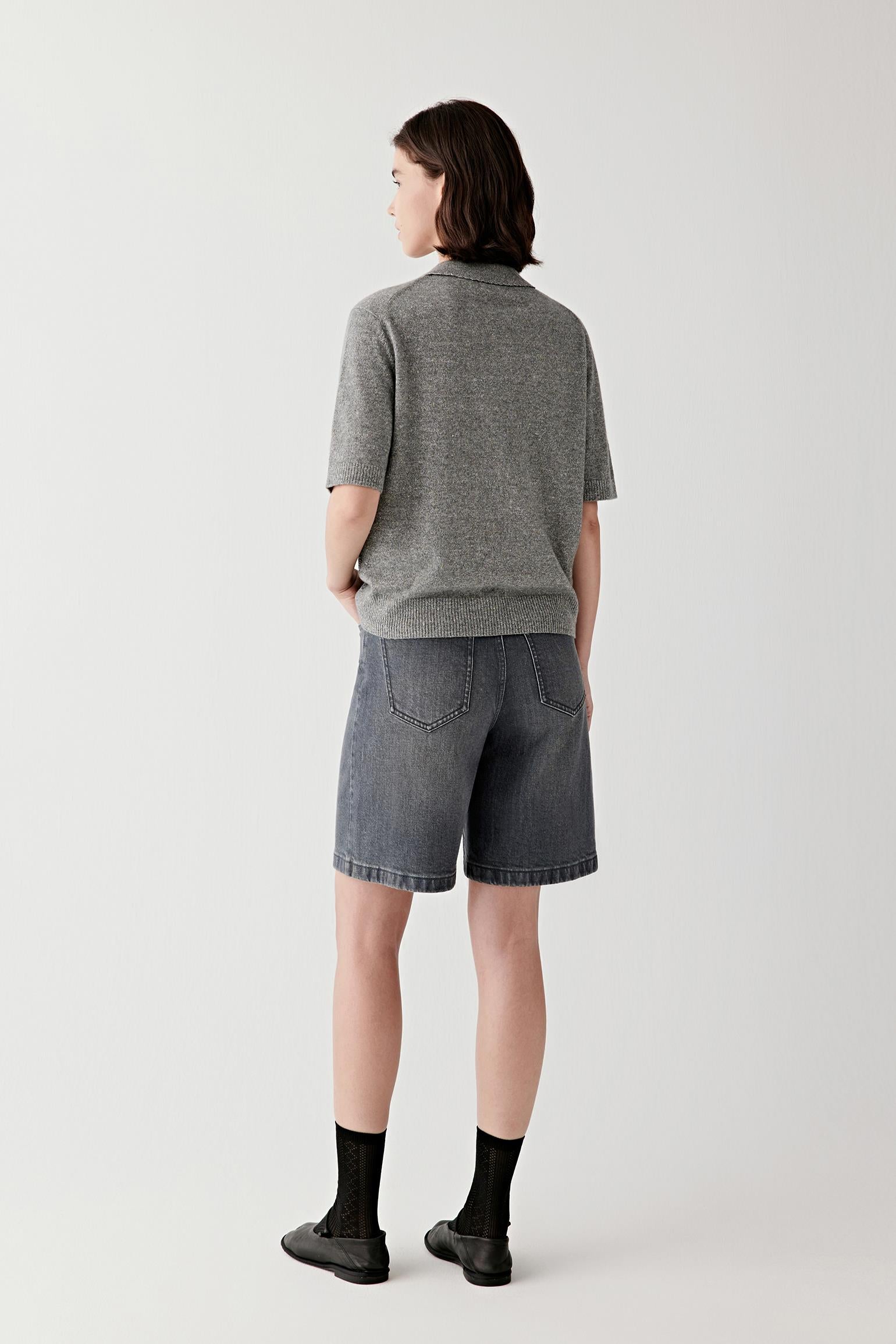 Back view highlighting pocket placement and structured denim finish.