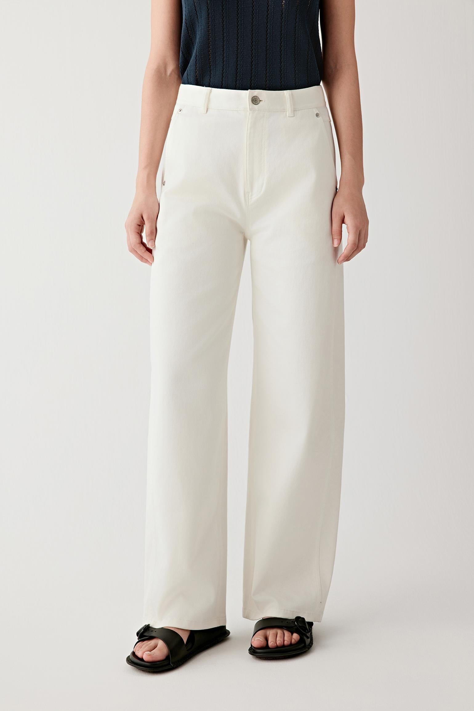 Mid-length front view focusing on the trousers from waist to hem, emphasizing the straight-leg cut, the balanced volume through the leg and the smooth, lightly textured woven denim surface
