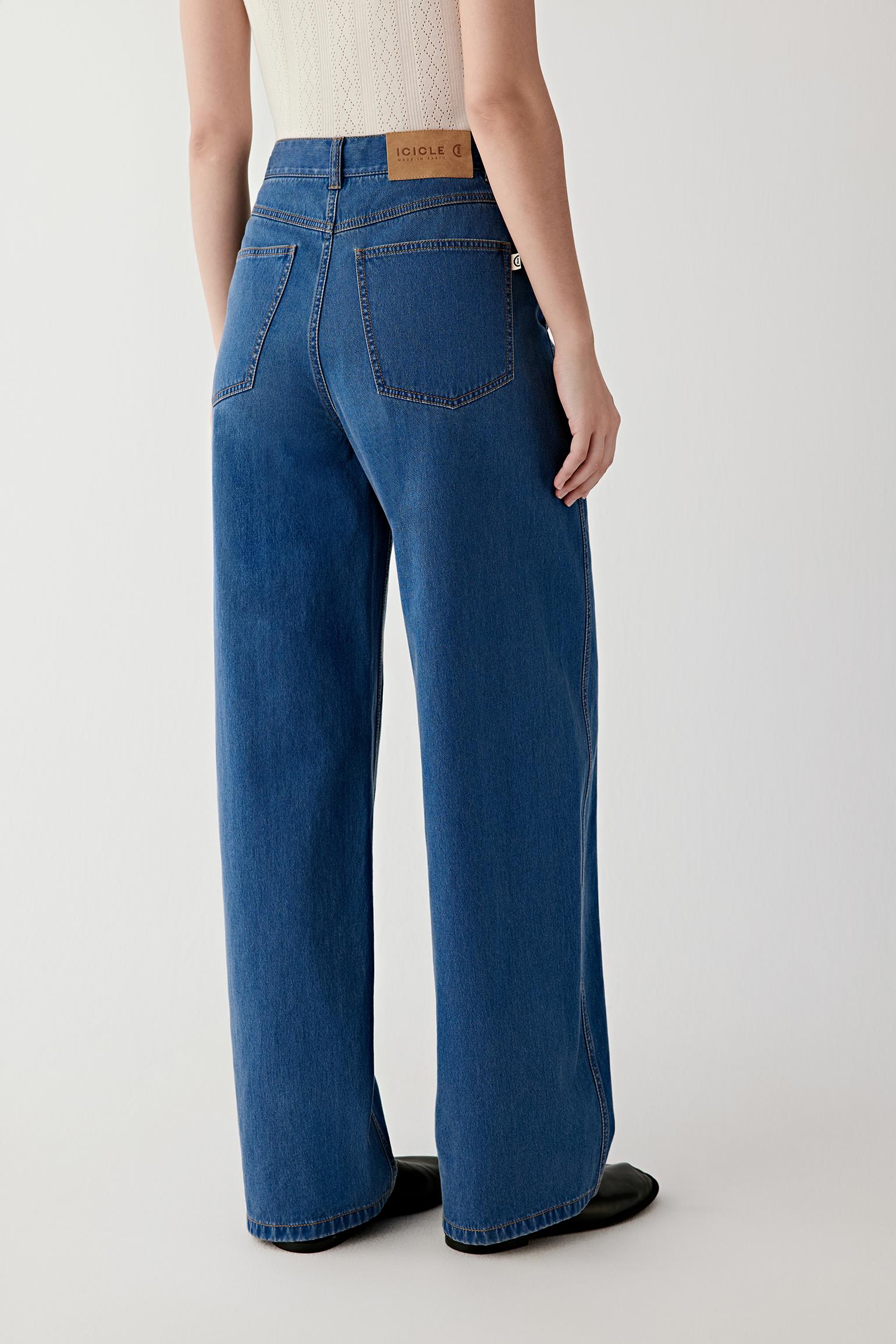 Back view showing the placement of back patch pockets, straight yoke line and clean fall of the denim along the legs.