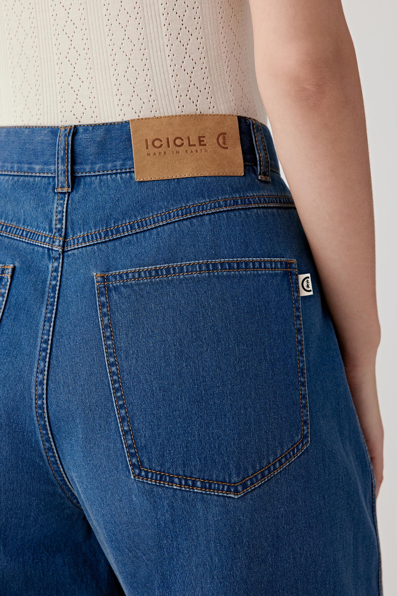 Close-up of the back pocket and waistband, highlighting the contrast stitching, patch pocket construction and leather label detail at the back waist.