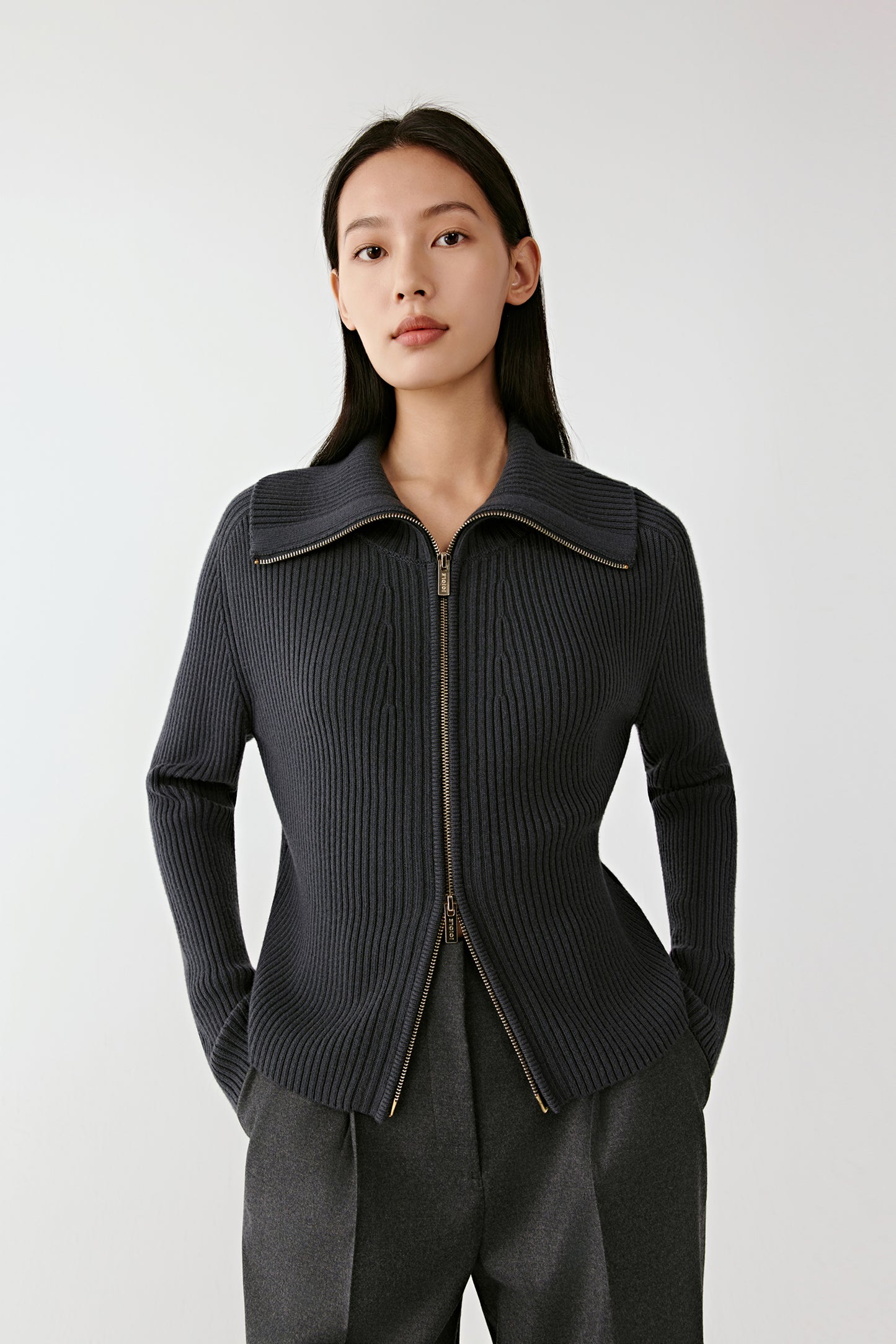 Front view of the blue ribbed semi-worsted wool zip cardigan, featuring a convertible collar and straight silhouette.
