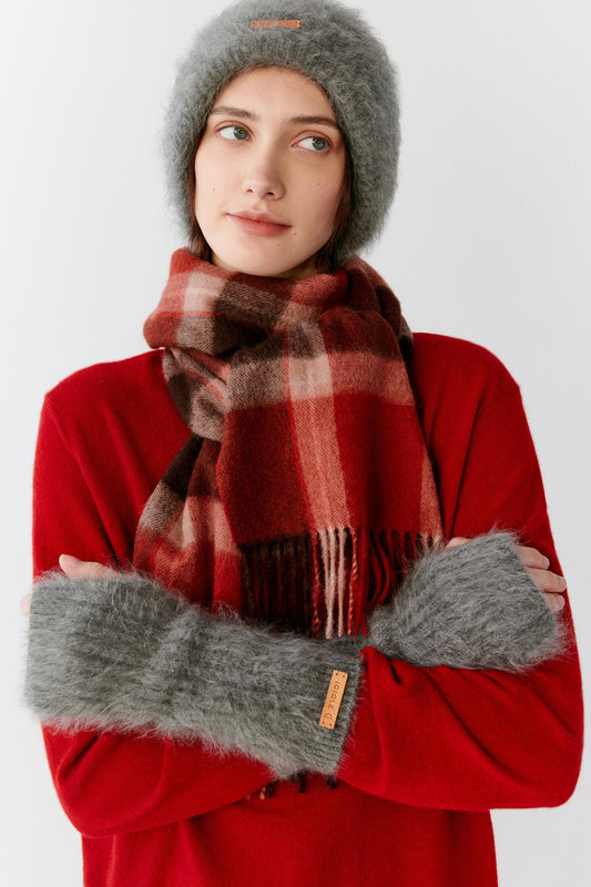 Front view of a woman wearing grey brushed cashmere gloves, showing the elongated shape and ribbed cuffs.