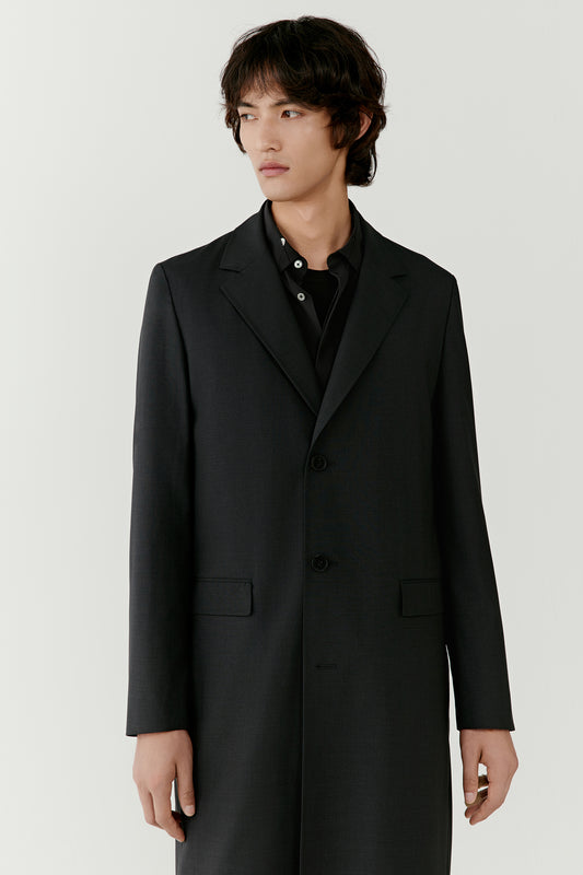 Front view emphasizing the straight silhouette and balanced proportions of the trench coat as it falls naturally along the body.