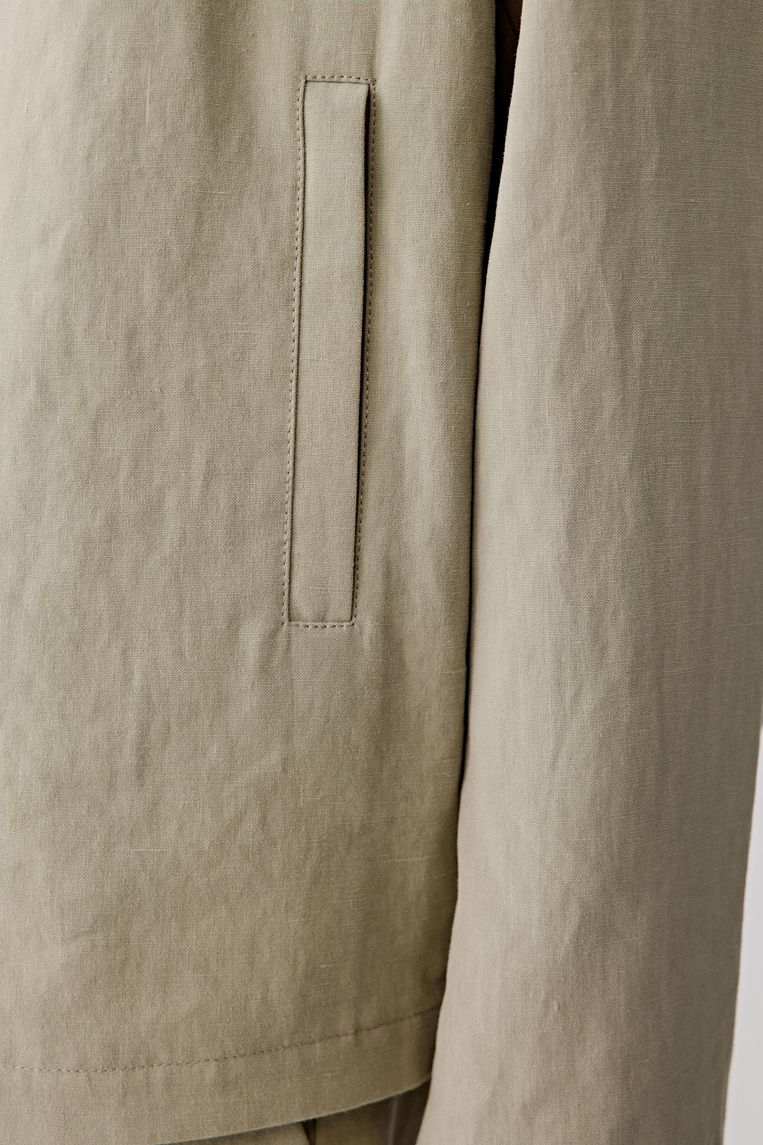 Close-up of the fabric and lower body area, emphasizing the vertical pockets, stitching details and the lightly textured surface, with visible weave irregularities enhancing the natural character of the linen