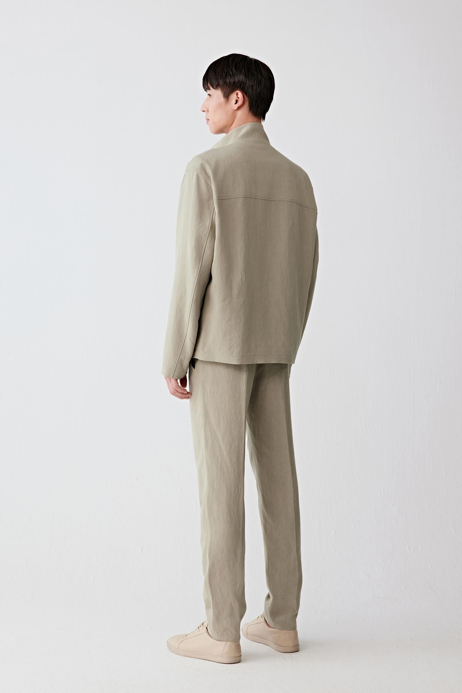 Full-length back view showing the rear silhouette, highlighting the relaxed shoulder line, straight cut and continuous fall from collar to hem, with the fabric maintaining a structured yet breathable form