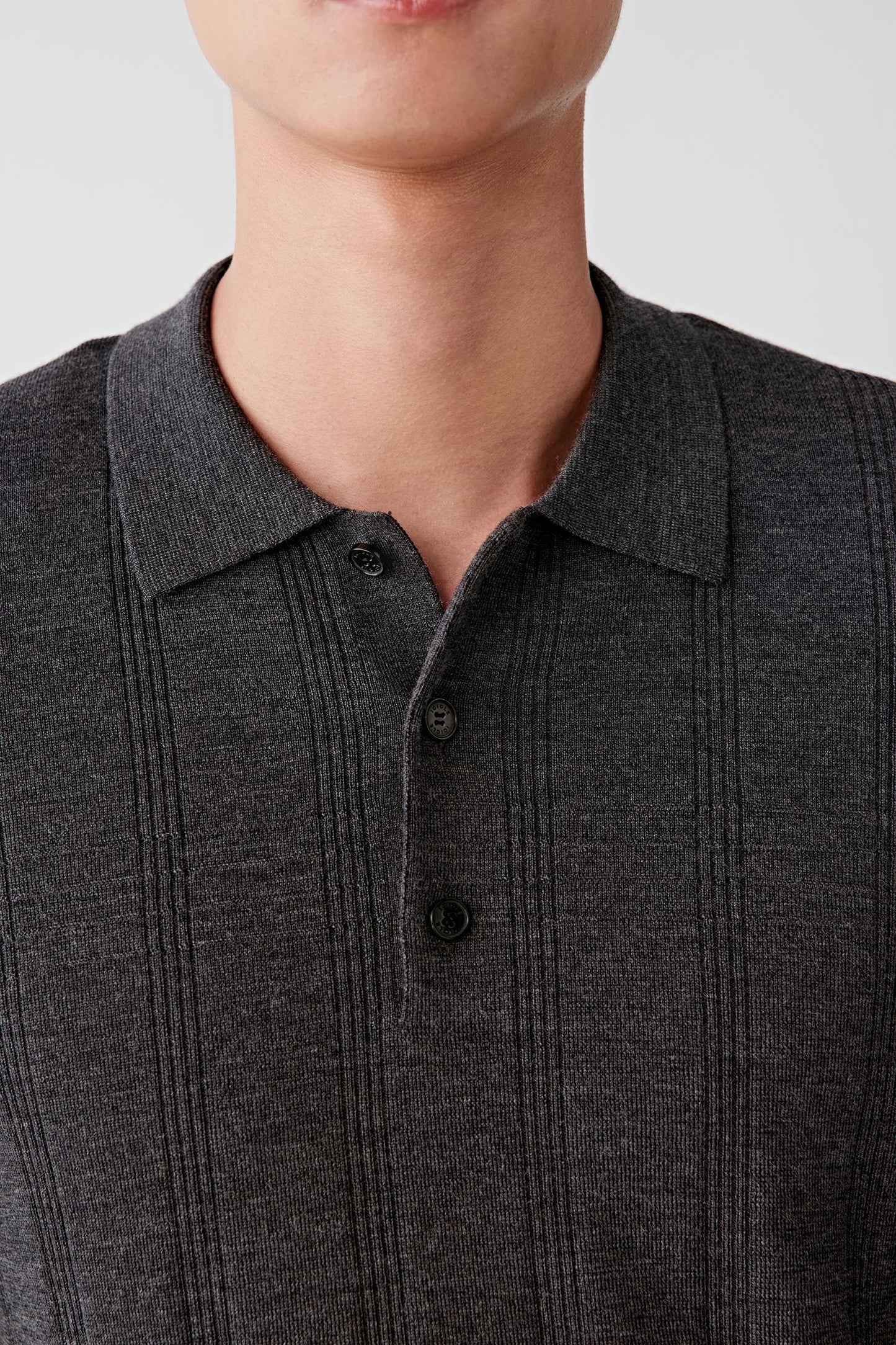 Close-up of the ribbed button placket at the neckline.