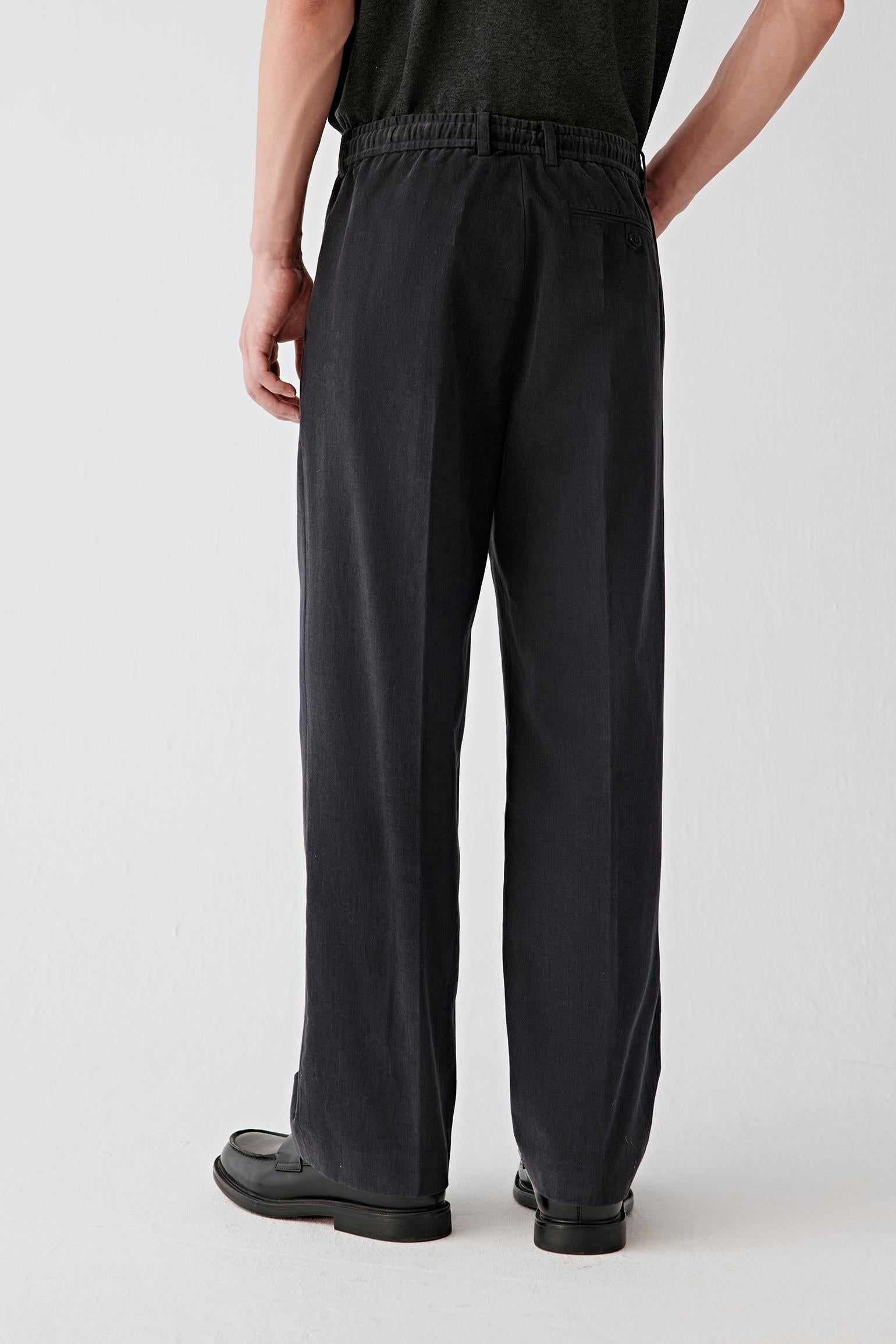 Back view emphasizing the fluid fall of the leg, relaxed silhouette and ease of movement.