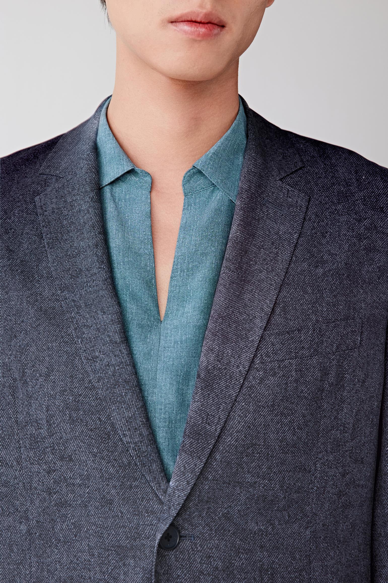 Close-up of the neckline and lapel, detailing the lapel construction, front opening and the fine twill texture, with a smooth, slightly lustrous surface characteristic of silk twill