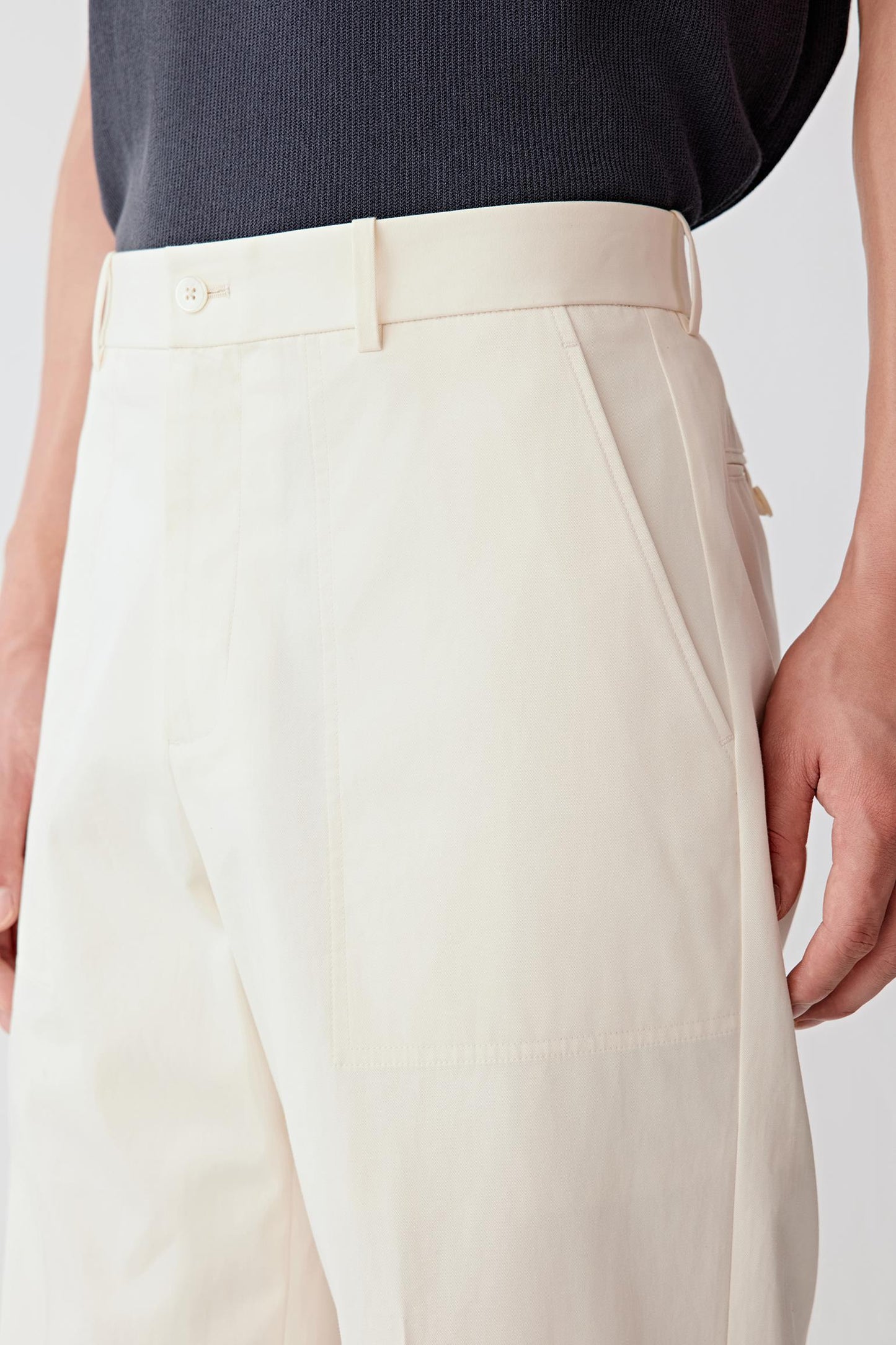 Close-up of the hip and side pocket, detailing the pocket construction, stitching precision and the dense twill weave, with a smooth, slightly firm hand feel