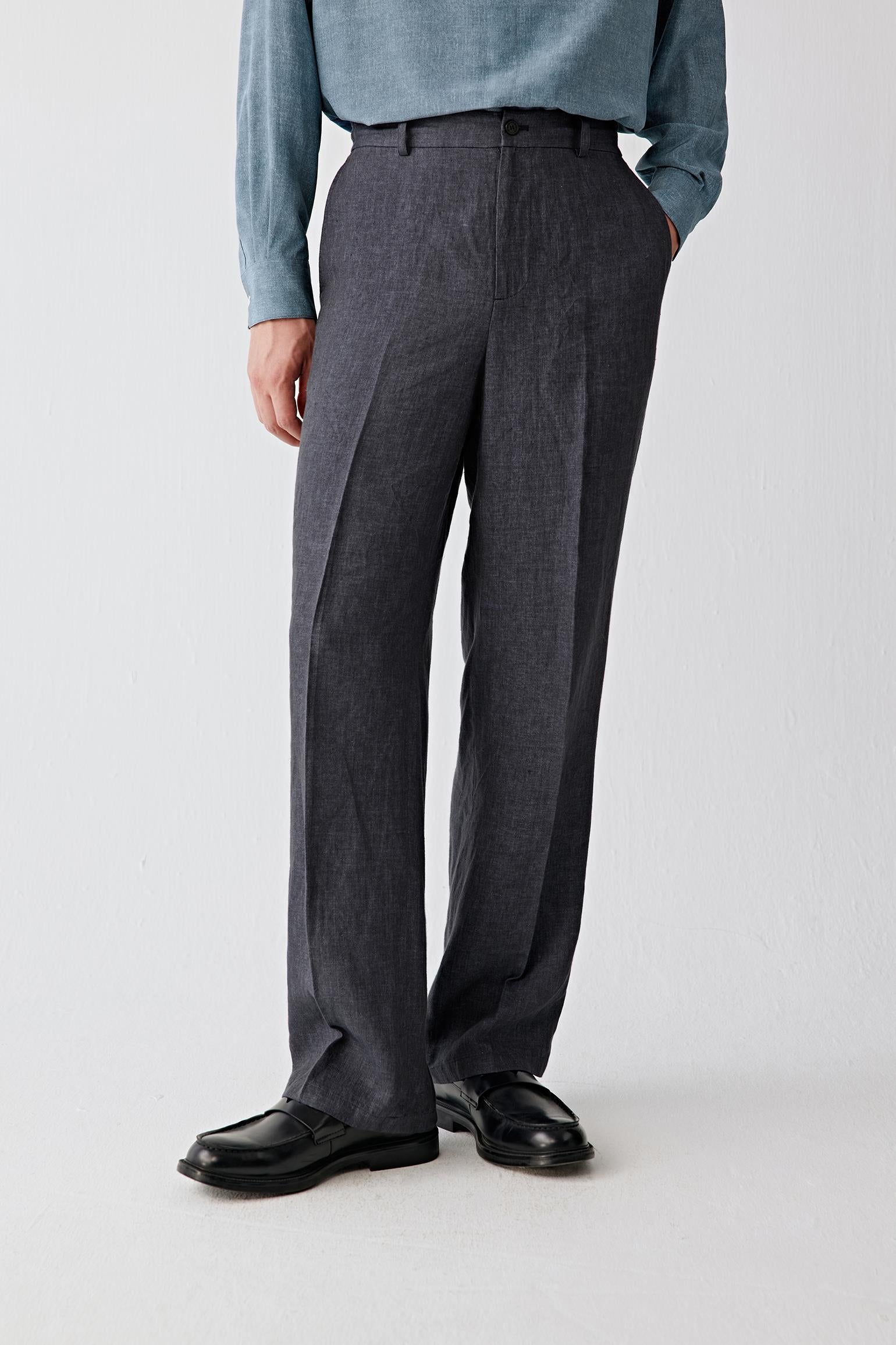 Mid-length front view focusing on the waist and upper leg, emphasizing the clean waistband, belt loops and discreet drawstring detail, with the deep blue tone revealing slight tonal variation and natural depth in the fabric