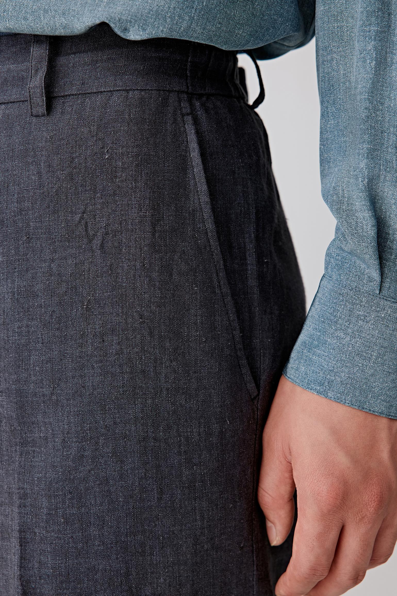 Close-up of the side pocket and hip, detailing the pocket construction, stitching precision and the matte linen surface with visible weave irregularities