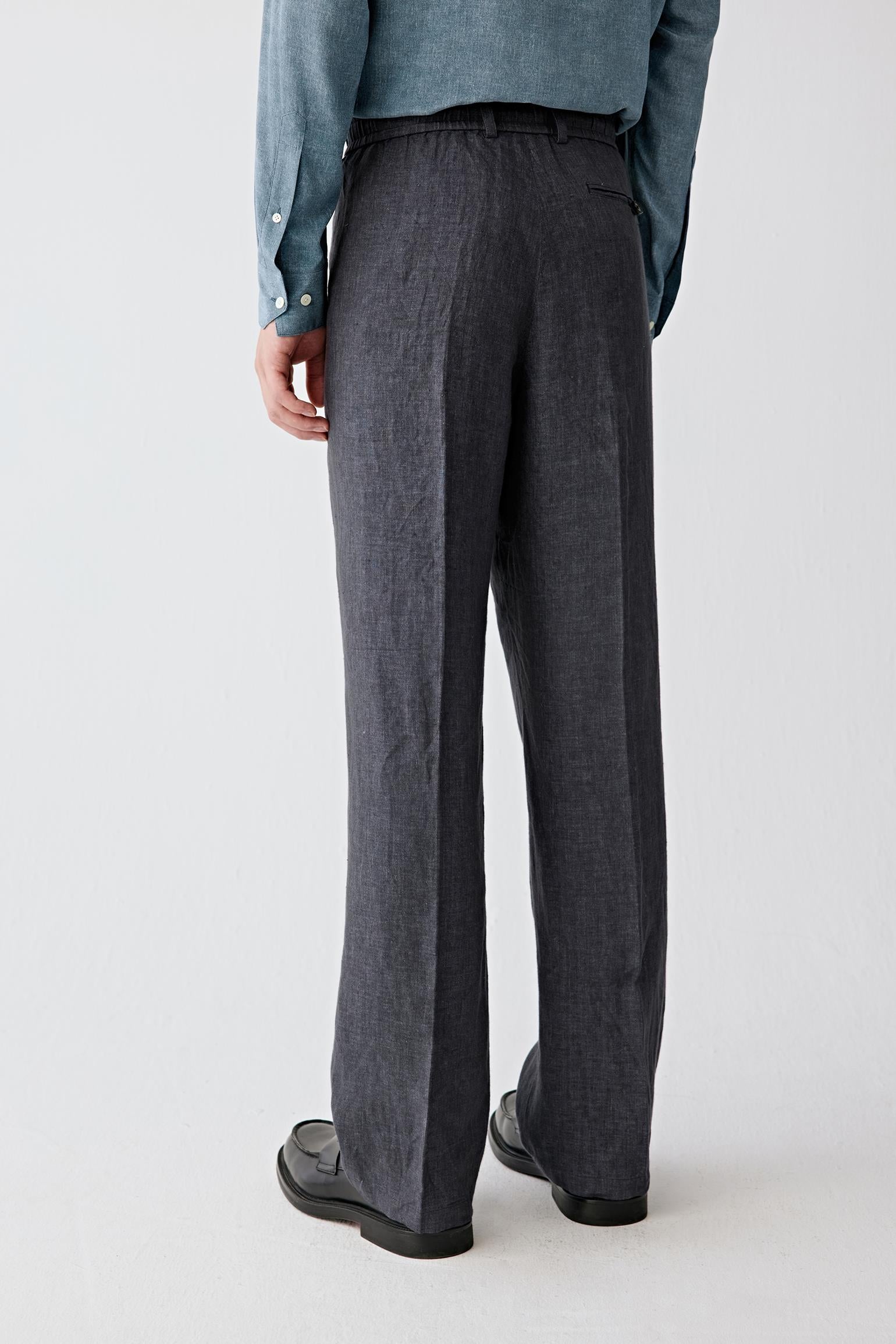 Full-length back view showing the rear silhouette, highlighting the straight cut and continuous vertical fall from waistband to hem, with a balanced structure that maintains shape while allowing natural movement