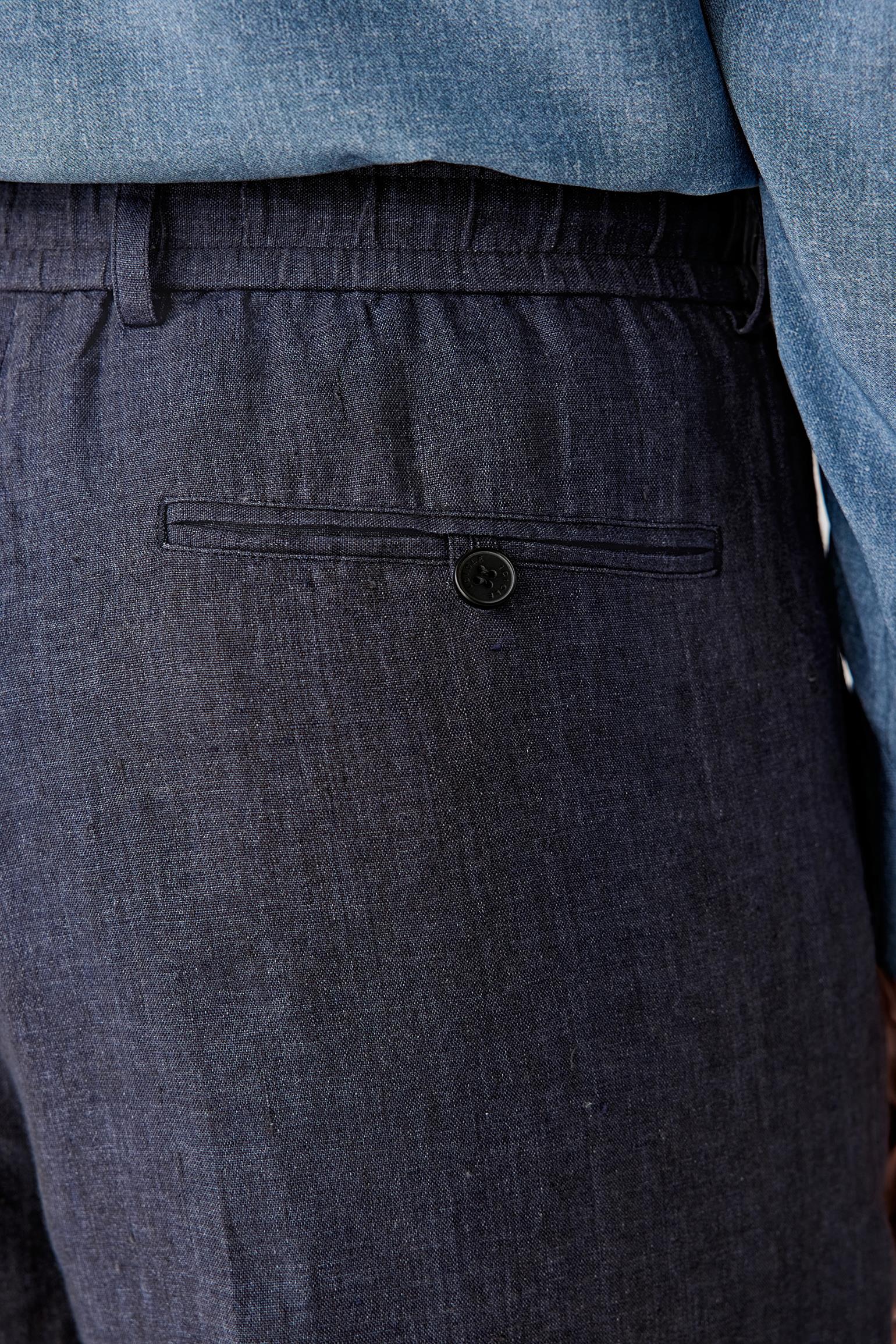 Close-up of the back pocket and waistband, highlighting the clean finishing, pocket placement and the drawstring integration, with the fabric showing a slightly crisp texture and subtle variations in the deep blue shade