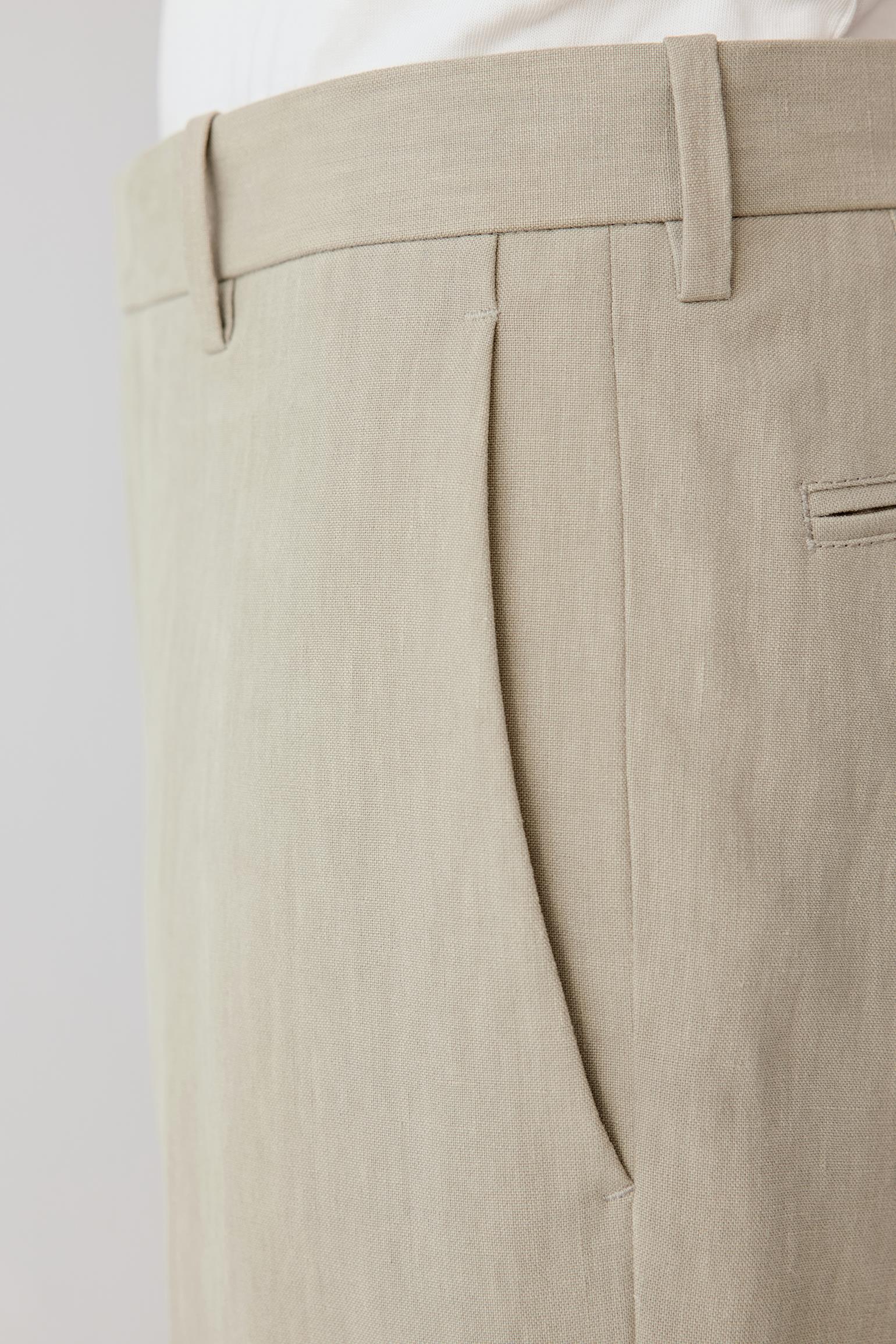 Close-up of the waistband and pocket showing the discreet pocket construction, stitching and subtly irregular linen texture.