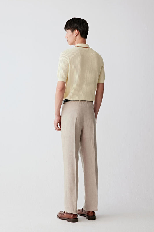 Side view showing the straight cut, short sleeves and fluid drape of the fine cotton knit. The image emphasizes the lightweight structure of the garment and the clean proportions of the silhouette.