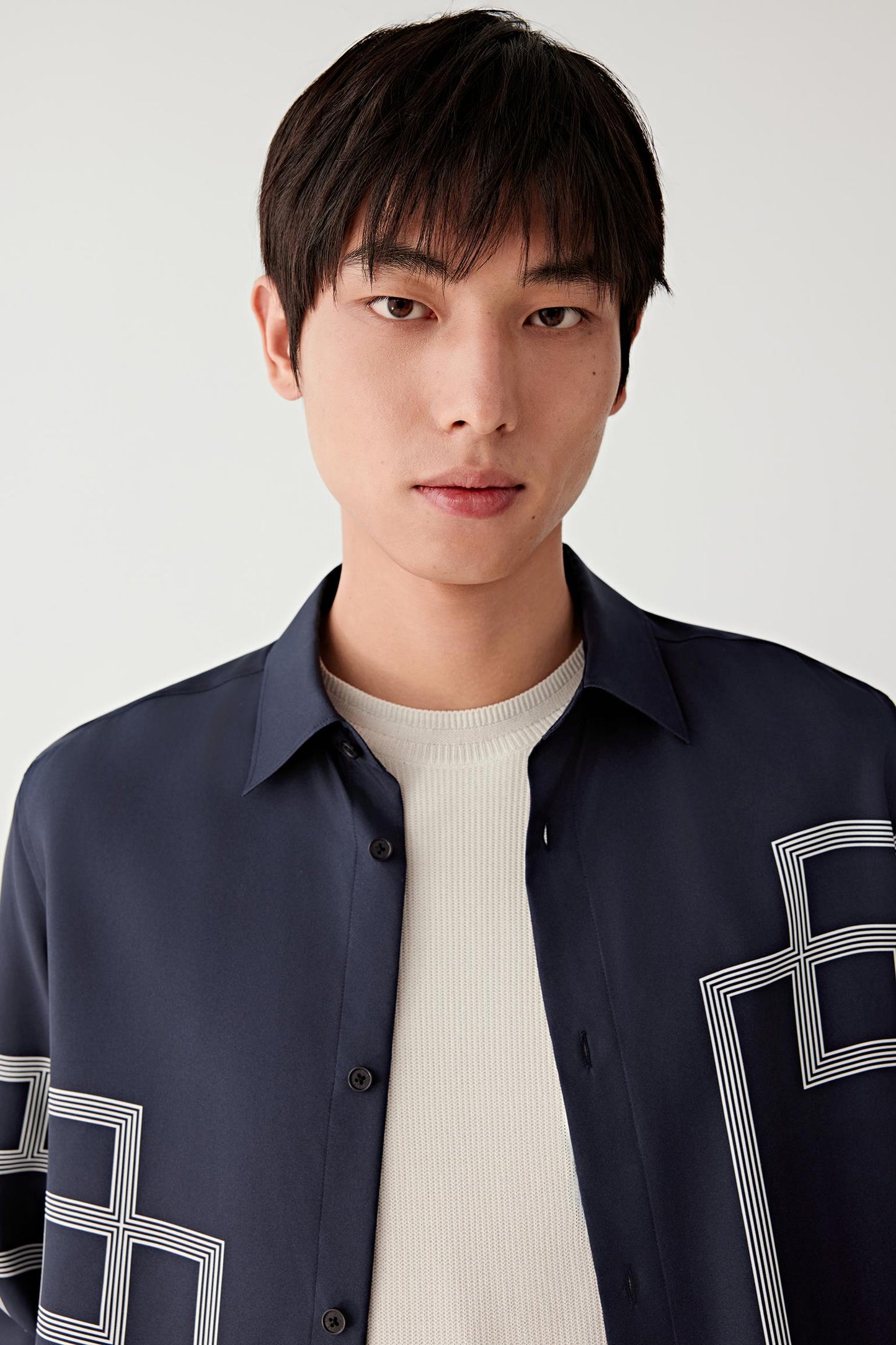 Close-up of the collar and upper chest showing the fine silk texture and precise pattern alignment.