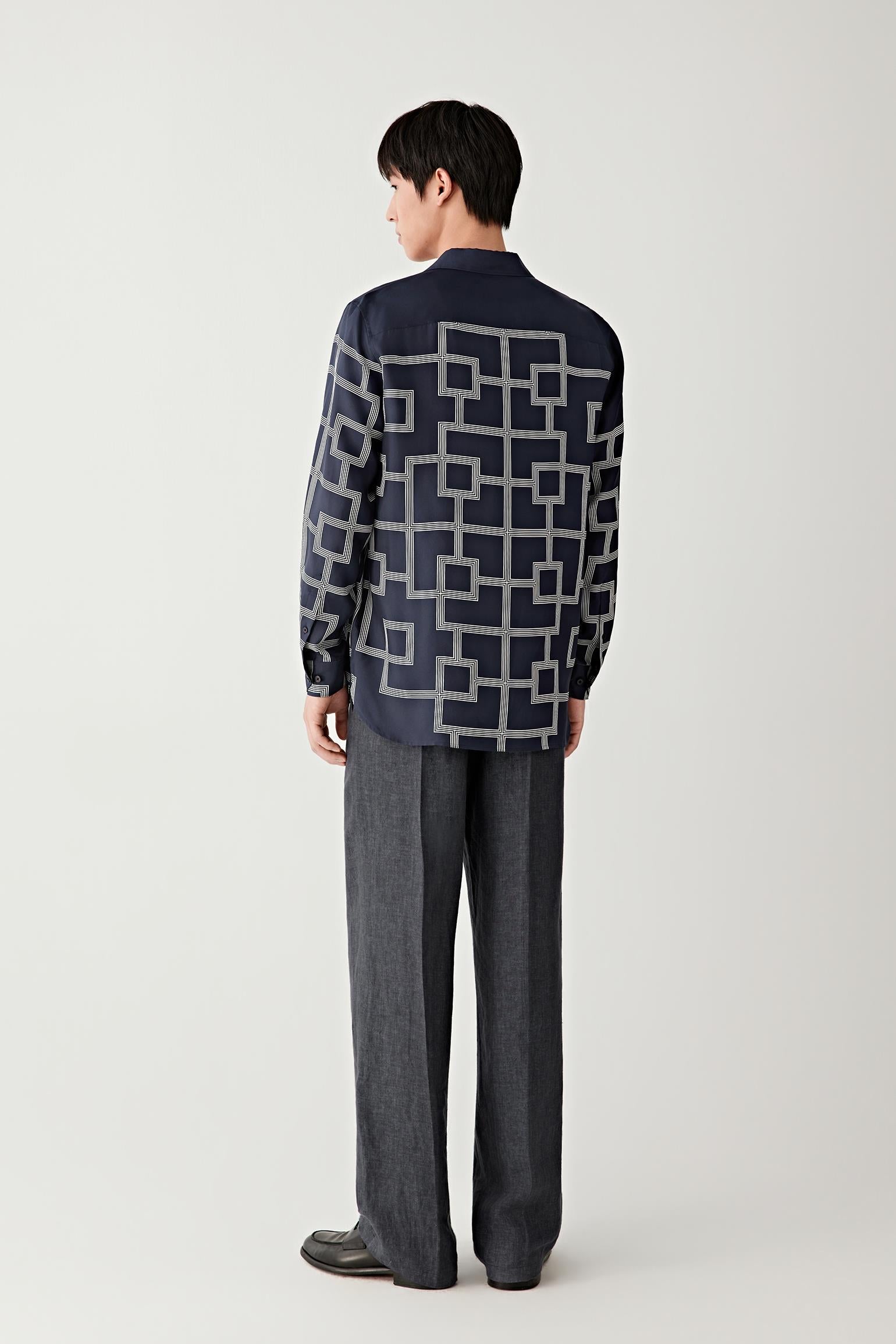Full-length back view showing the structured straight fit and all-over geometric motif.