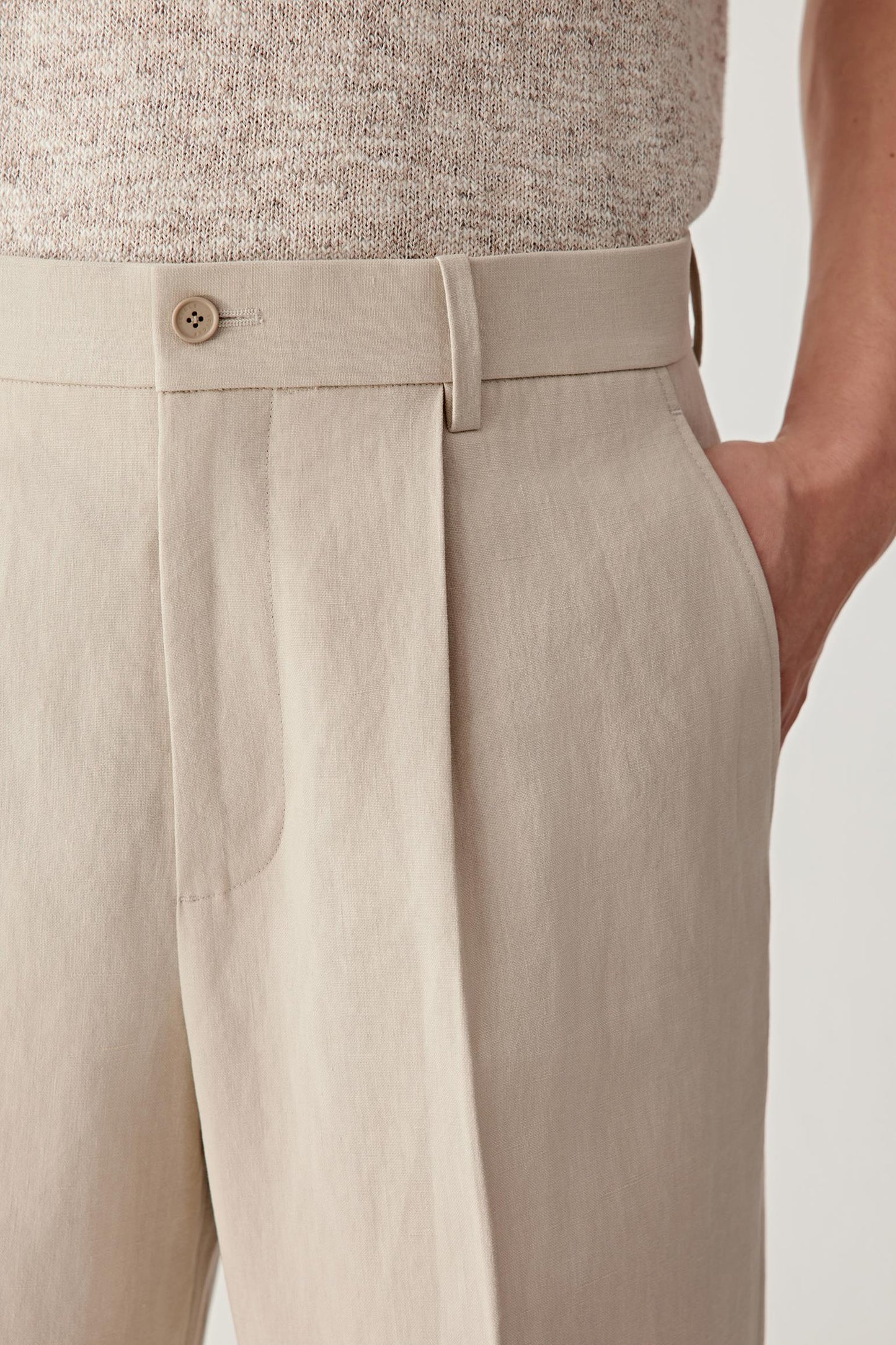 Close-up of the hip and side pocket, detailing the pocket construction, stitching precision and the slightly irregular texture of the twisted linen yarn, with a matte surface and visible grain