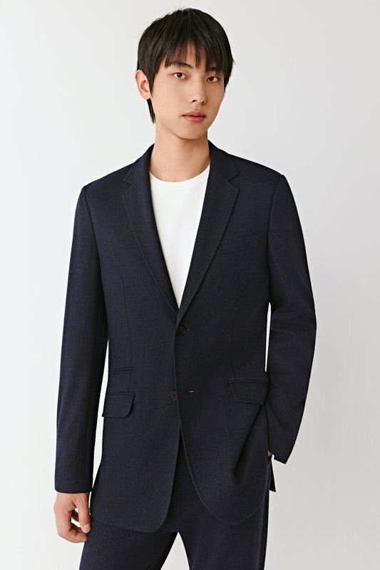 Portrait focusing on the classic lapel and neat finish of the fabric.