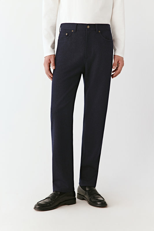 Overall detail on the trousers, highlighting the seams and the grain of the fabric.