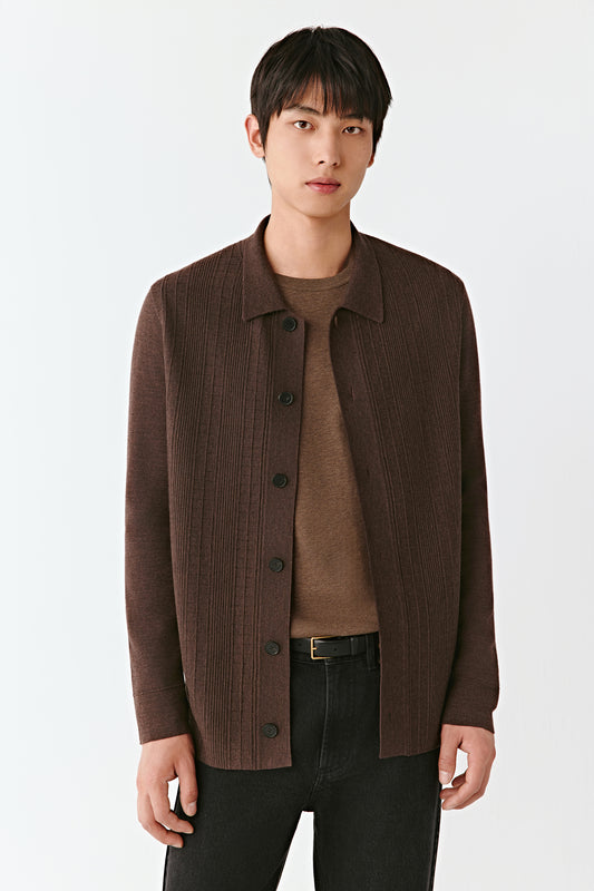 Man wearing a brown jacket over a brown shirt on a white background