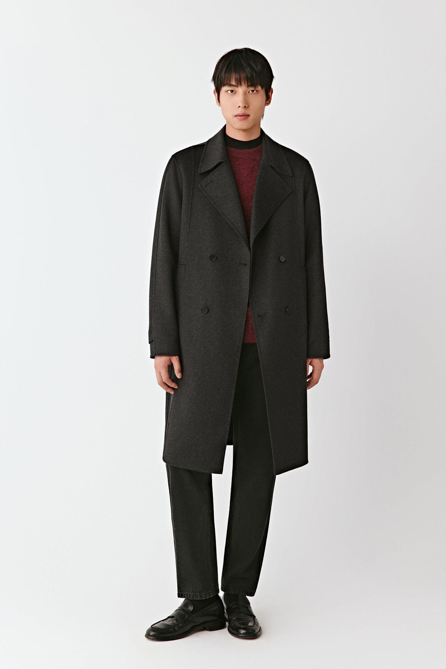 Man wearing a black coat on a white background