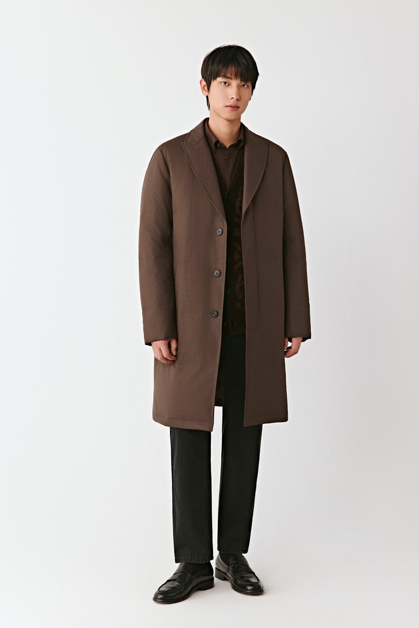 Man wearing a brown coat on a white background