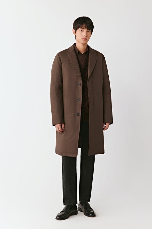 Man wearing a brown coat on a white background