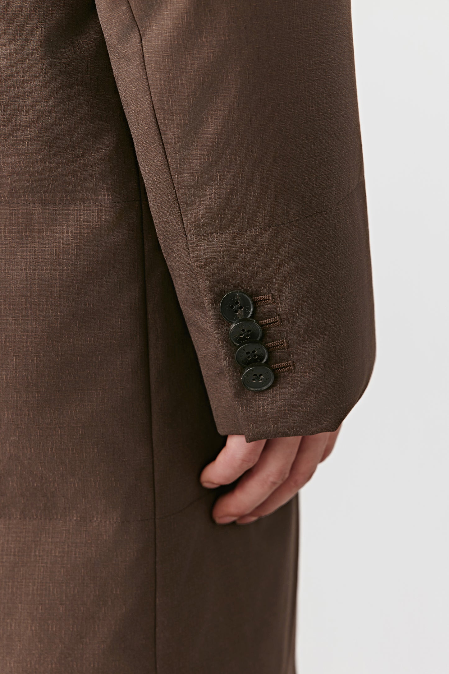 Brown suit jacket with buttons on a white background