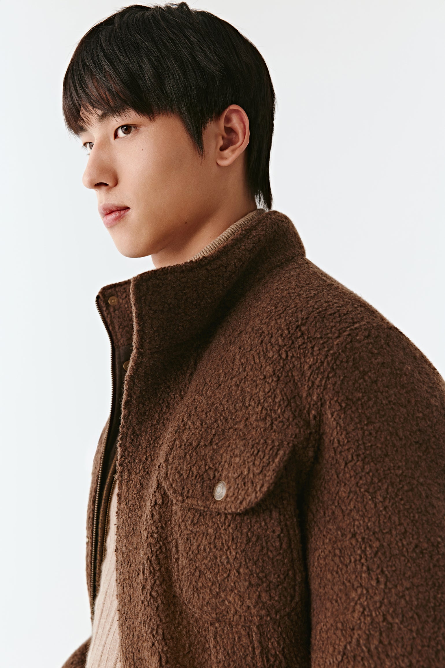 Man wearing a brown jacket on a white background