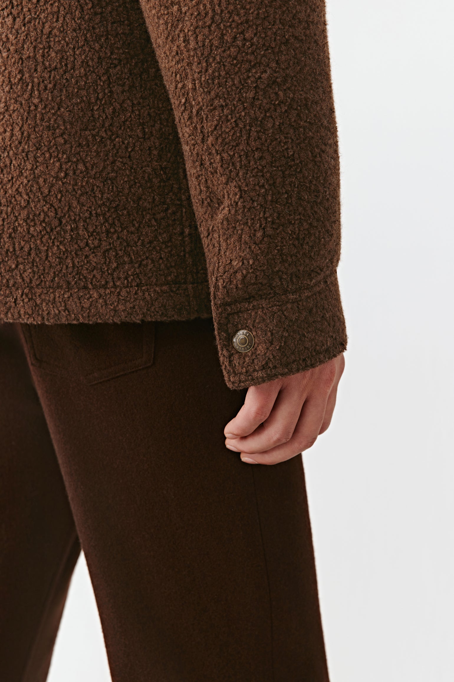 Brown textured jacket and pants on a white background