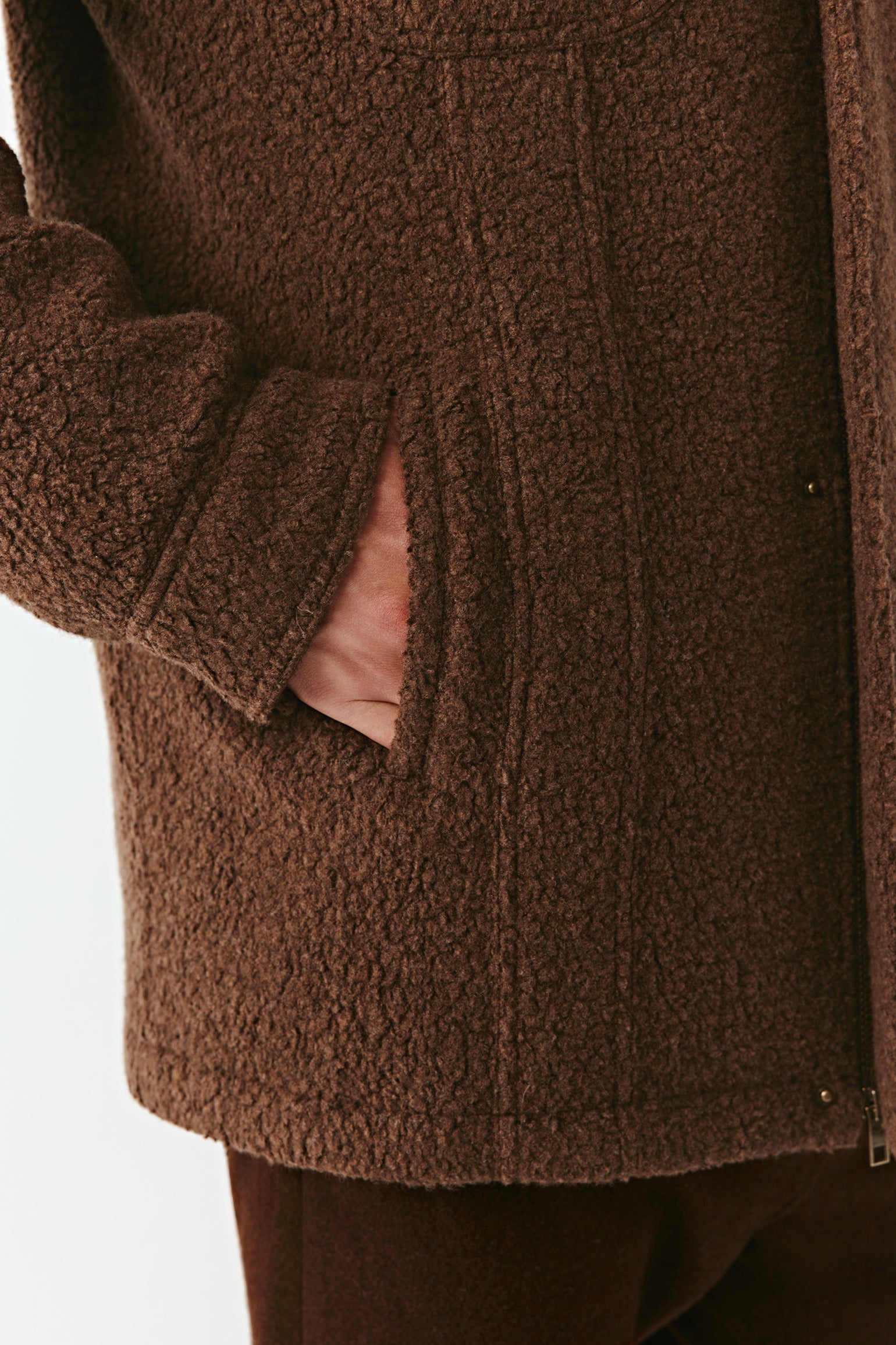 Close-up of a brown textured coat with a white background