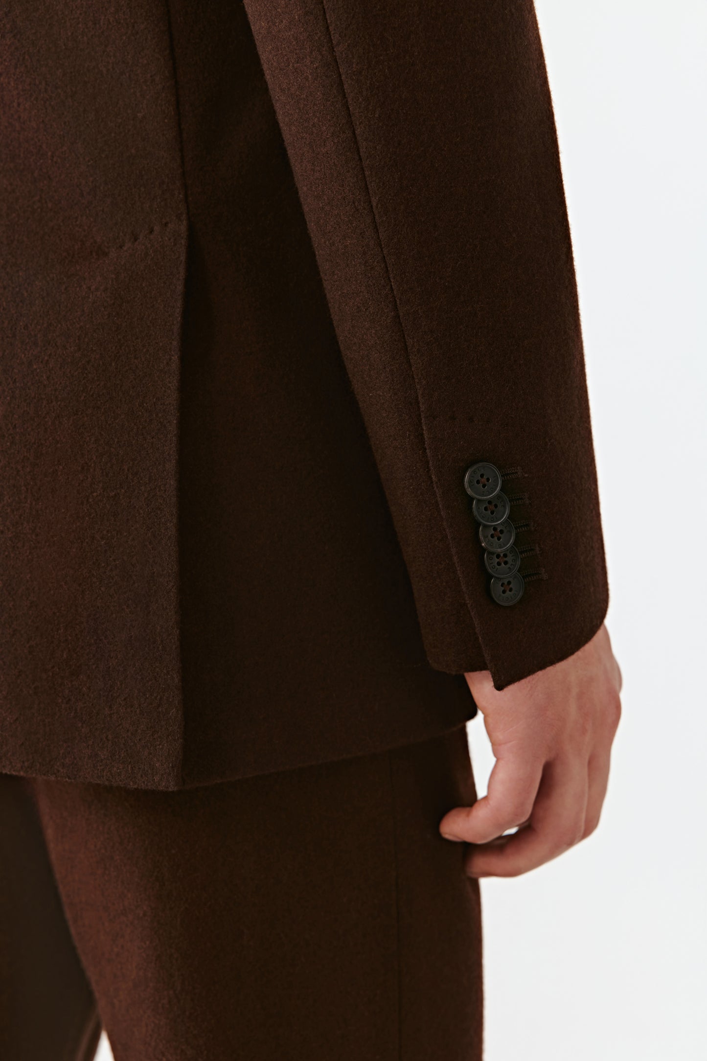 Brown suit jacket with buttons on a white background